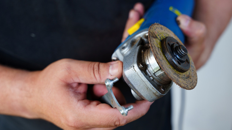 Person holding angle grinder