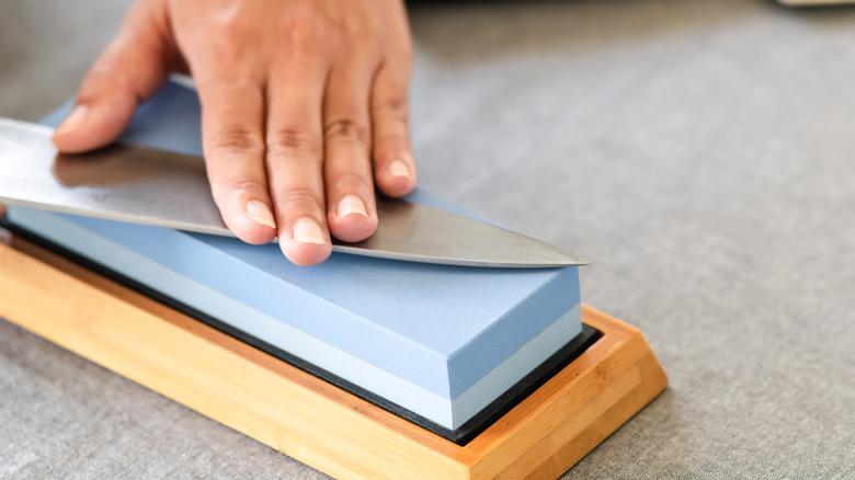 Using a whetstone to sharpen a kitchen knife