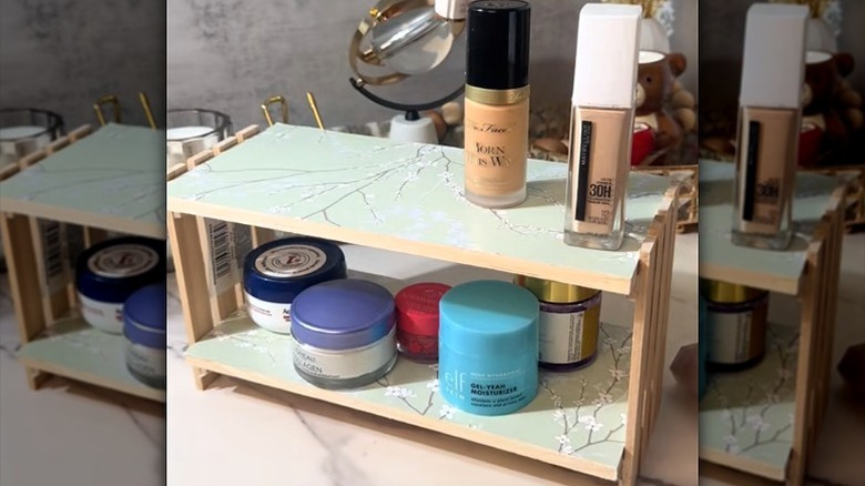 Makeup stored on DIY two-tiered shelf made from Dollar Tree supplies