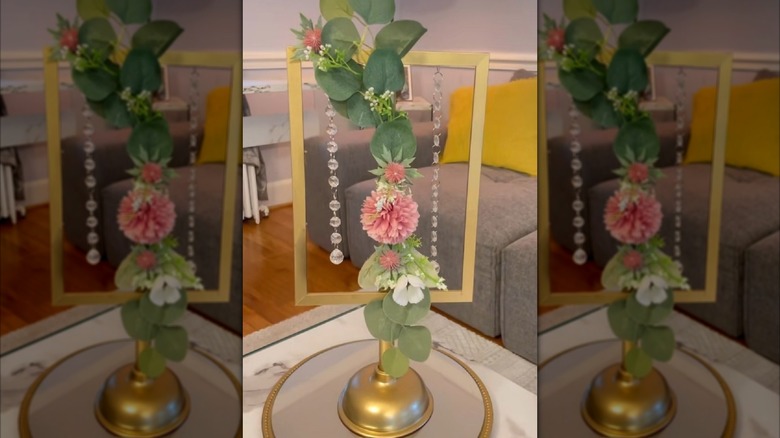 Dollar Tree plunger and frame turned into centerpiece decor with flowers and beads