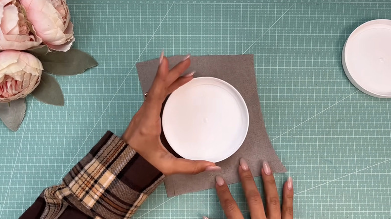 Creator covering a lid with fabric