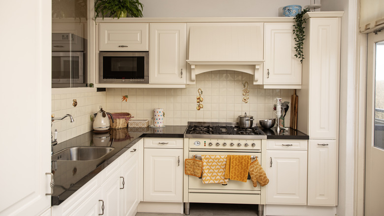 A kitchen with white painted cabinets