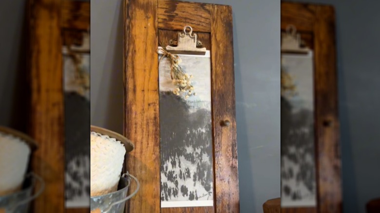 Art display made with an old cabinet door and clipboard hardware