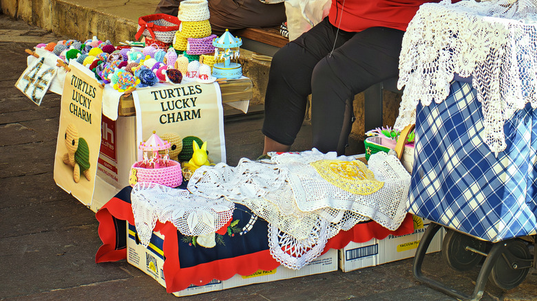 Piles of doilies in a box at a vendor's booth