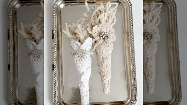 Two small doily carrots fastened to a small silver tray