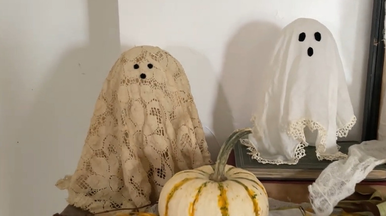 Two doily ghosts sitting on a table