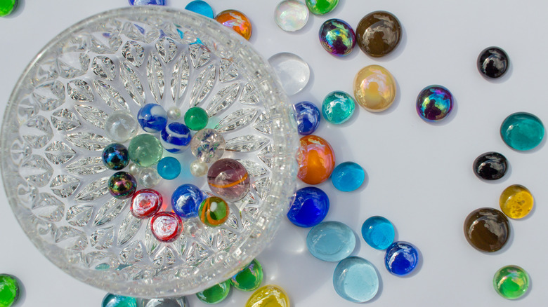 A glass bowl with gems.