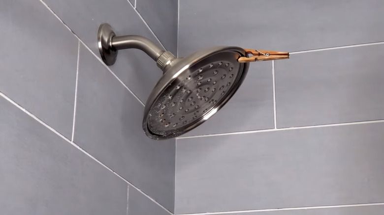 essential oil soaked clothespin on showerhead