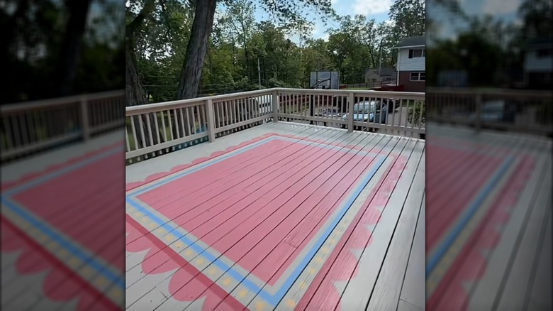 A deck with a rug painted onto the wood planks