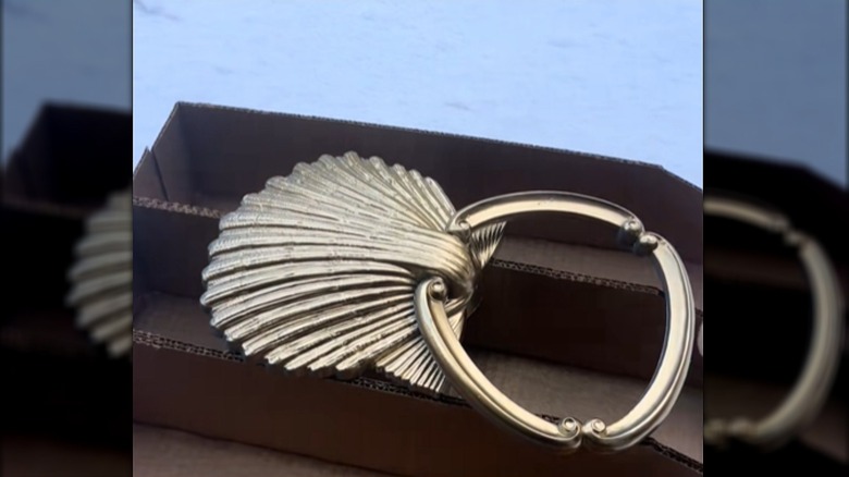 A vintage seashell towel holder spray painted gold