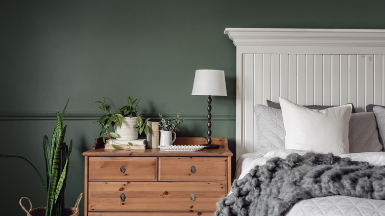 a bedroom wall painted a similar color to Sherwin-Williams Garden Gate color