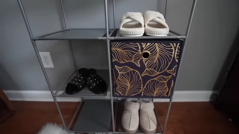 A Dollar Tree cube storage rack holds shoes and bins for compact, affordable organization