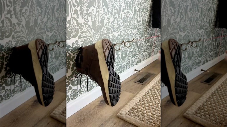 A brown shoe hanging on a wall hook