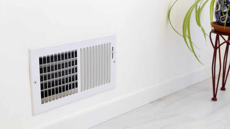 Close-up of a wall air vent on a gray wall