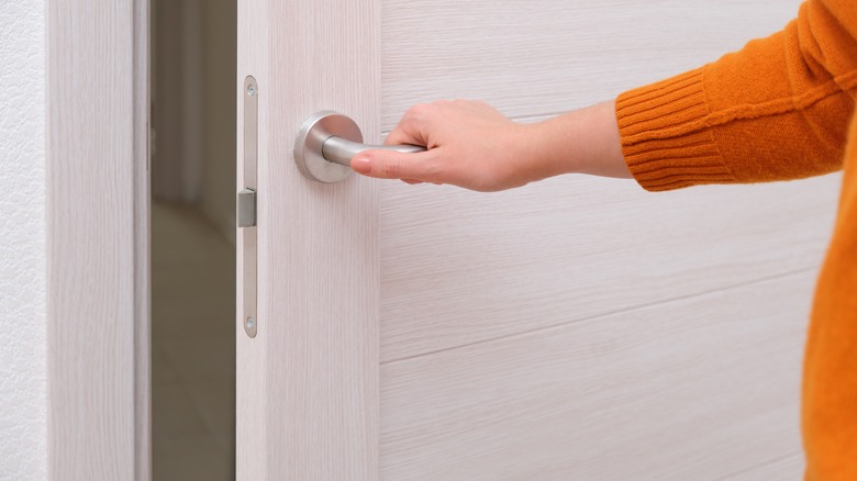 hand grabbing door handle