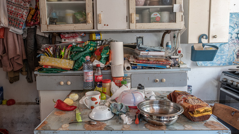 Kitchen with cluttered counter and island