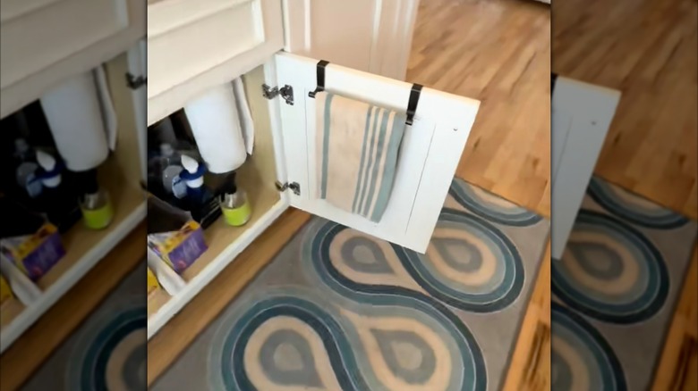 A towel holder inside a cabinet door