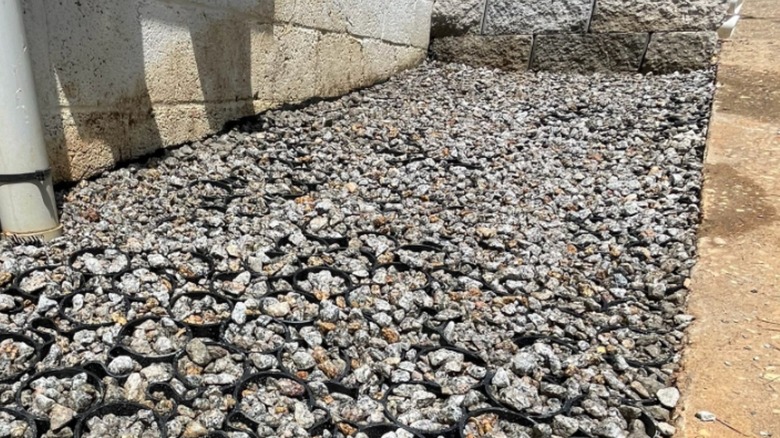 Solid gravel pad built with a permeable paver grid