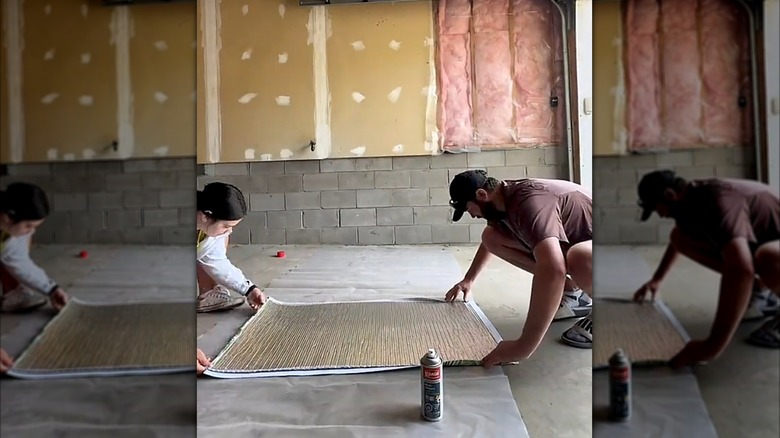 A couple gluing reflective insulation to fabric