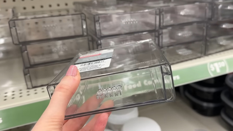 Creator holding a plastic drawer at Dollar Tree
