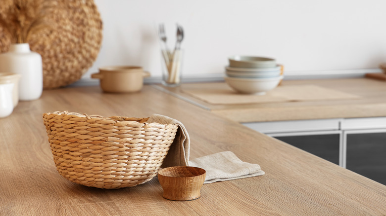 A wicker basket sitting on a wooden countertop.