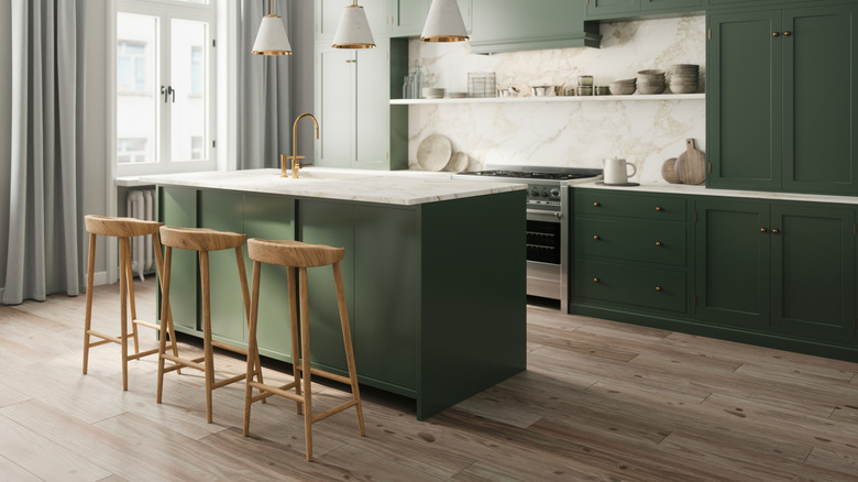 Stone-look kitchen backsplash in modern kitchen with sage cabinets