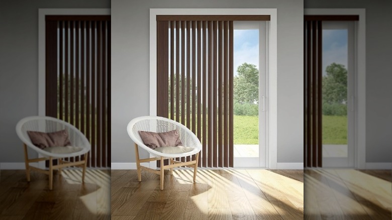 A sliding glass doors with fabric vertical blinds