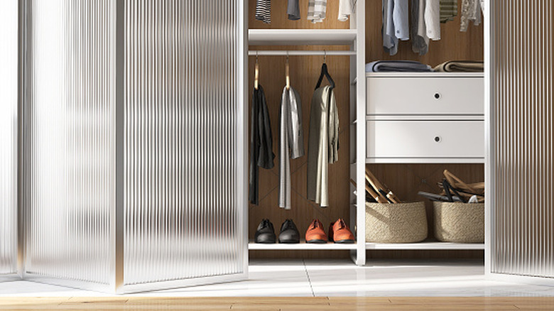 Neatly organized closet with a half-open French bifold door