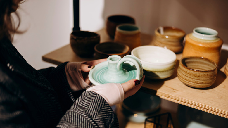 Person shopping for candle holders