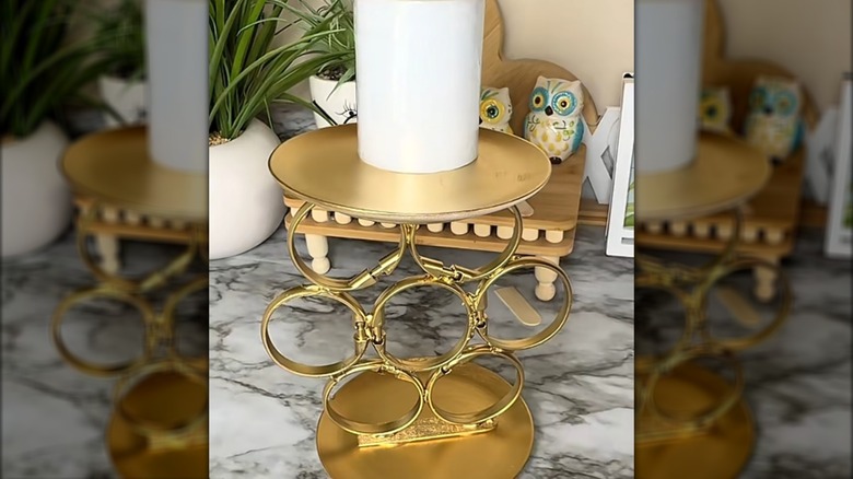 DIY candle holder made from plates and curtain rings glued together and spray painted gold