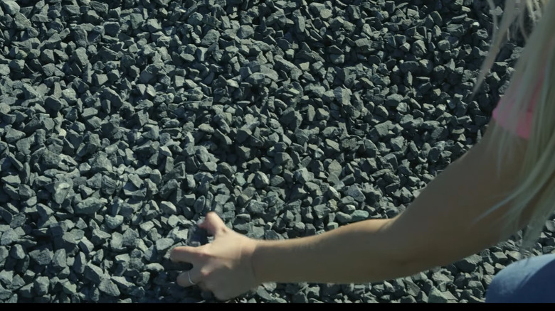 Person picking up Black Star gravel