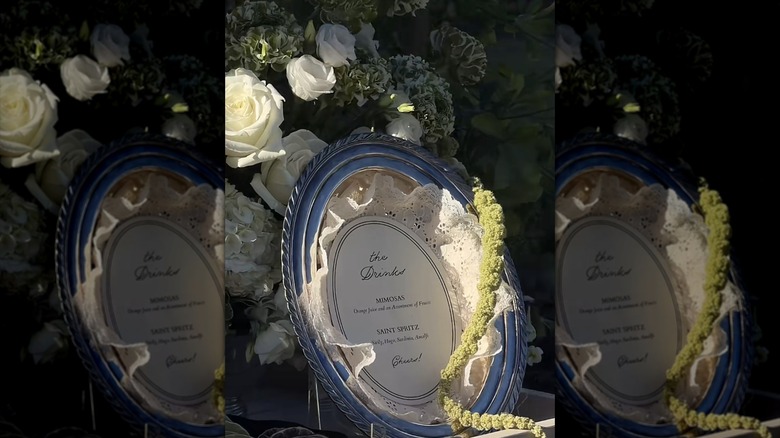 A vintage tray and doily with a drink menu on a cart near flowers