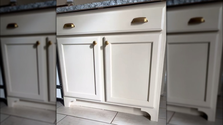 White kitchen cabinet with custom-built toe kick legs attached to the base