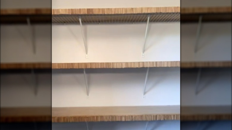 Wire closet shelves covered with wood and a DIY fluted front