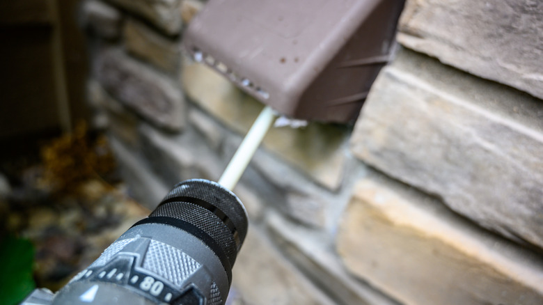 Using a spinning brush to clean a dryer's exhaust vent