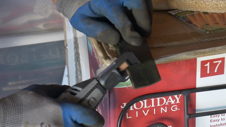 Sharpening a mower blade with a Dremel attachment