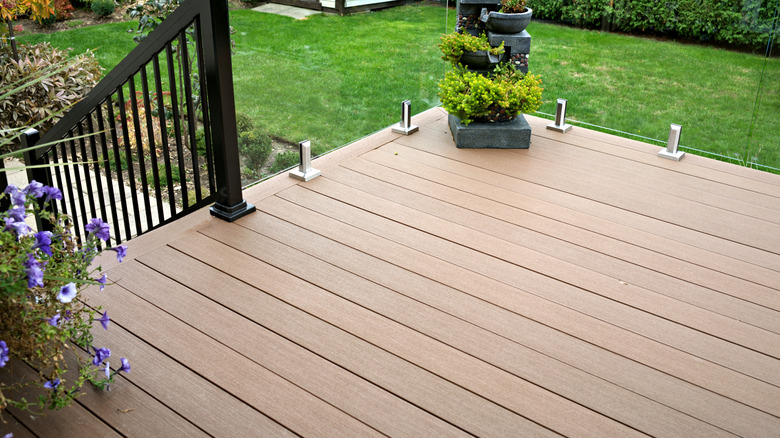 composite deck patio with glass panel railing