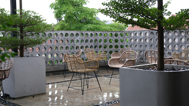 patio with modern boho chairs atop polished concrete