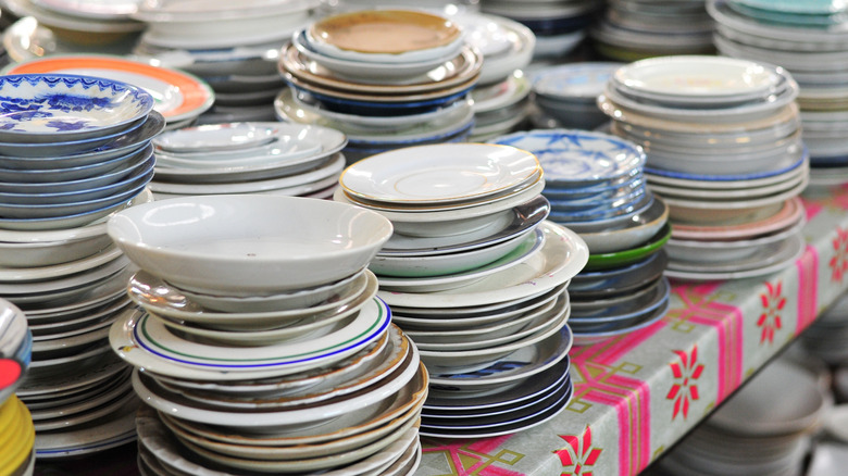 Mixture of vintage dishes on thrift store shelf