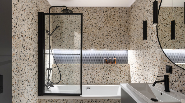 Modern terrazzo bath and shower enclosure with tub screen