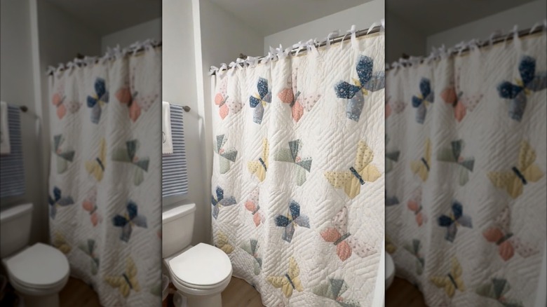 Quilt with butterflies used as shower curtain in bathroom