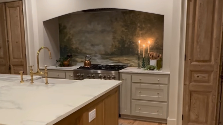 A painted mural behind a stove