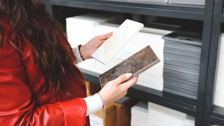Woman comparing different types of tile