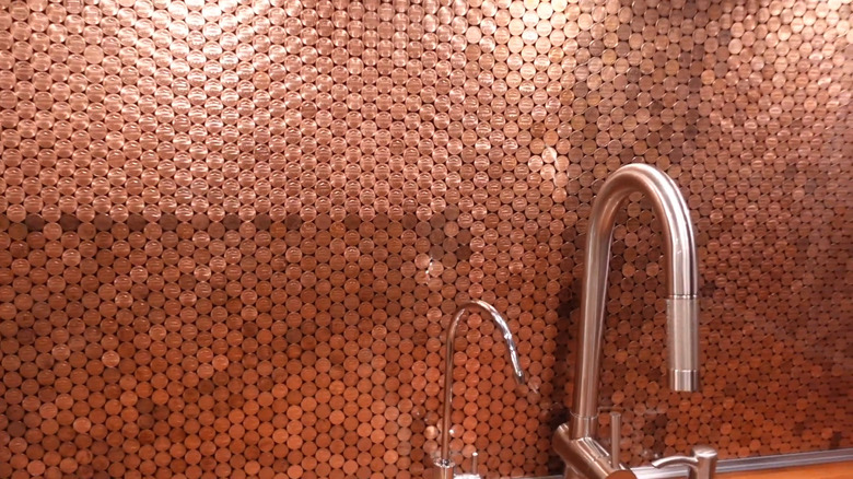 A backsplash made of pennies behind a sink