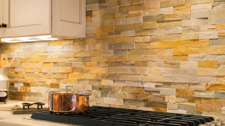Rustic kitchen counter with stone veneer backsplash