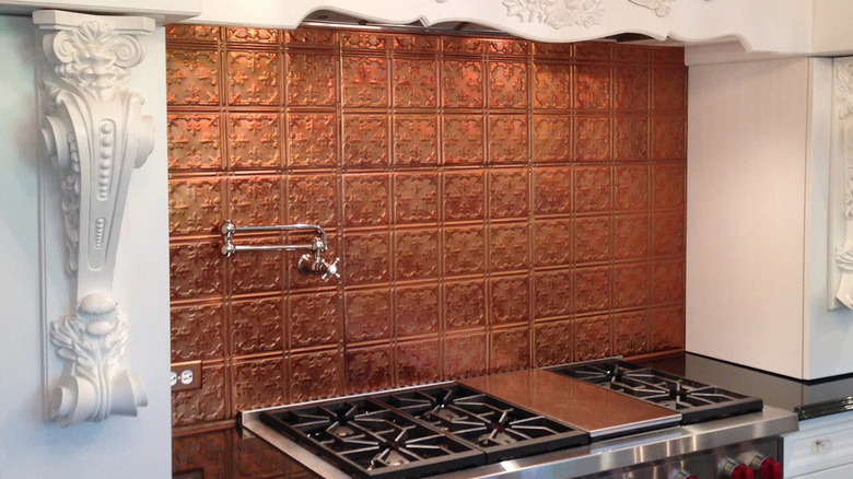 A stove with a textured metal backsplash