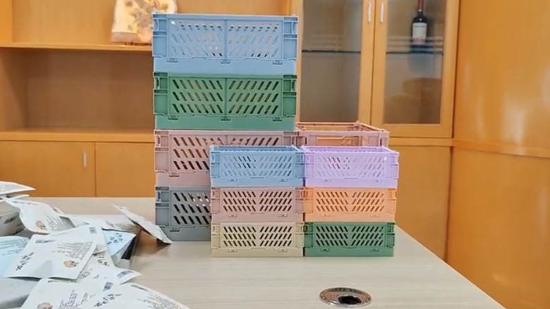 Stacks of Huusmot 6-Pack Collapsible Plastic Storage Baskets in various sizes