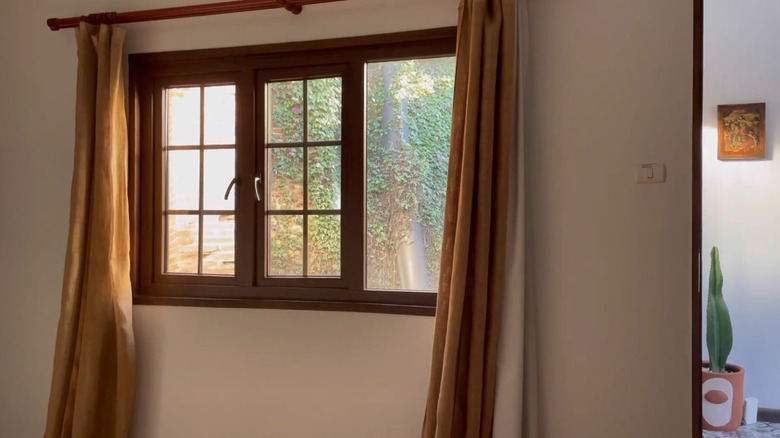 Burlap curtains framing a window on a sunny day