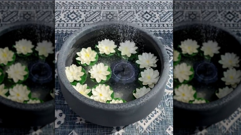 DIY deck fountain made from planter, floating decor, and solar-powered pump