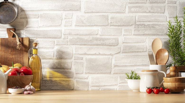 Whitewashed brick backsplash above kitchen counter